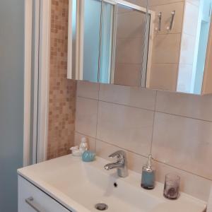 a bathroom with a sink and a mirror at Apartment Vanda in Splitska +56 photos