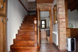a wooden staircase in a home with a brick wall at Casa Carmen y Mera in Ferroñes