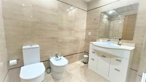 a bathroom with a toilet and a sink and a mirror at BEACH VALENCIA LUXURY A40-13 Apartment with terrace and sea views in Valencia