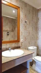 a bathroom with a sink and a toilet and a mirror at Hotel Nou Can Guillem in Cala Figuera +24 photos