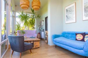 a living room with a blue couch and a table at Apartamenty Rodzinne Plater74 in Darlowko