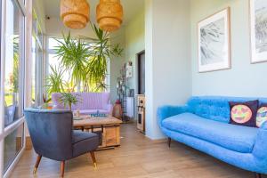 a living room with a blue couch and a table at Apartamenty Rodzinne Plater74 in Darłówko