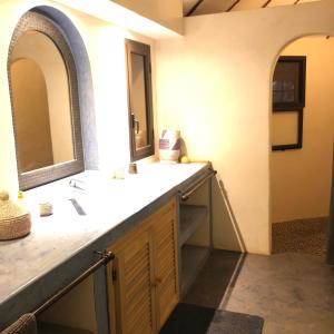 a bathroom with a sink and a mirror at Toubana Lodge in Ngaparou +49 photos