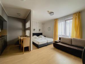 a hotel room with a bed and a couch at Royal Mediterran in Siófok +176 photos