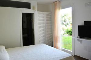 Ένα ή περισσότερα κρεβάτια σε δωμάτιο στο Porto Pino Club