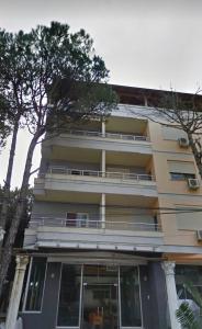 a tall building with a balcony on the side of it at Cheap 2+1 apartment, 10 meters from beach in Golem