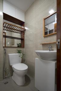 a bathroom with a toilet and a sink at Homestay TITO in Ho Chi Minh City