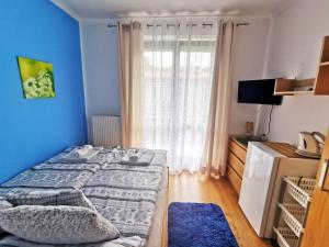 a bedroom with a bed and a large window at willa Majfill in Szklarska Poręba