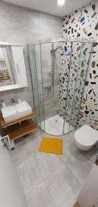 a bathroom with a shower and a toilet and a sink at Apartments & Rooms KARLA in Dramalj +59 photos