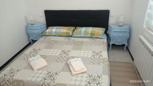 um quarto com uma cama e duas mesas de cabeceira azuis em Ela dream em La Spezia