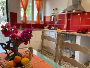 a kitchen with a vase of flowers on a table at Angeliki Studio and Apartment in Gaios