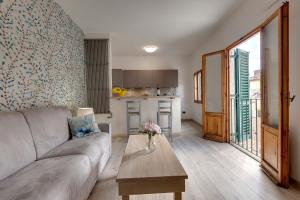 a living room with a couch and a table at Lezioso, Apartments in Florence in Florence