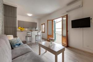 a living room with a couch and a table at Lezioso, Apartments in Florence in Florence