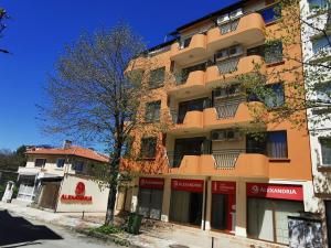 a tall orange building on a city street at Hotel Atanasov 1 in Primorsko