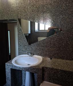 a person taking a picture of a sink in a bathroom at Estombar Novo in Estômbar +23 photos