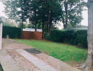 a backyard with a fence and a grass yard at Prestige Static Caravan on 5 Star Holiday Park in Cheswick