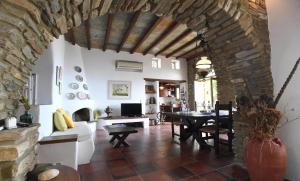 a living room with a table and a stone wall at Villa theassis in Arnados