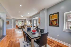 a dining room and living room with a table and chairs at Spacious 5-BR House near Transit w Parking in Chicago