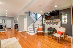 a living room with a fireplace and a staircase at Spacious 5-BR House near Transit w Parking in Chicago