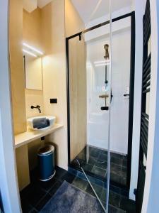 a bathroom with a shower and a sink at Private studio, patio garden and free car parking in Amsterdam +17 photos