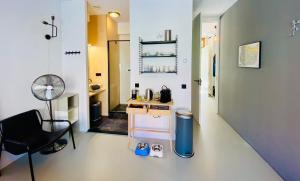 a room with a desk and a chair in a room at Private studio, patio garden and free car parking in Amsterdam