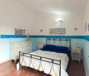 a bedroom with a bed and two night stands at Casa Vacanze VILLA SANDRINA in Costa Paradiso