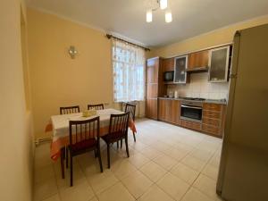 a kitchen and dining room with a table and chairs at Apartment at Bagramyan Street in Yerevan