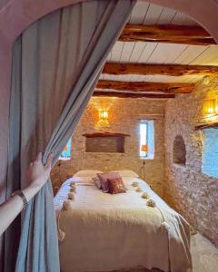 a person is standing in a bedroom with a bed at Atlantis 12, Maison d'hôtes et d'art in Essaouira