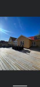 a building with a deck with benches in front of it at luksus spahus i skagen in Skagen