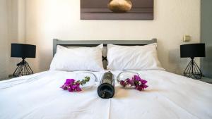 a camera on a bed with flowers on it at Old Trading House in Kalkan