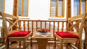 a table with two chairs and a glass of wine at Old Trading House in Kalkan