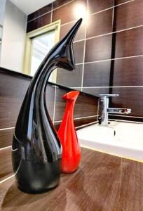 two vases sitting on a counter next to a sink at 1410Encorp/Bathtud/Netflix/100mbps/Legoland By STAY in Nusajaya