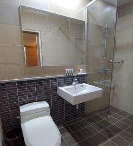 a bathroom with a toilet and a sink and a shower at Hotel Icc in Daejeon