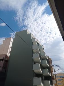 a building with balconies on the side of it at Elaėa Boutique Apartments in Piraeus