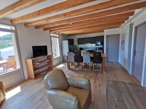 a living room with a couch and a table at Villa au lac du Salagou - 10 pers in Octon