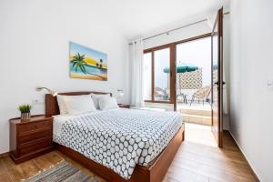 a bedroom with a bed and a view of the ocean at Casa da Tita Alvor in Alvor