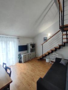 a living room with a staircase and a couch at Baška Voda - Apartmani Vesna in Baška Voda