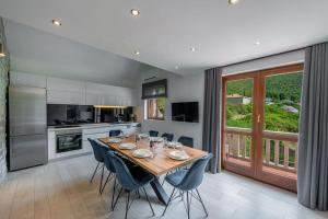 a kitchen with a wooden table and blue chairs at Vacation home with Private heated Pool in Zaton