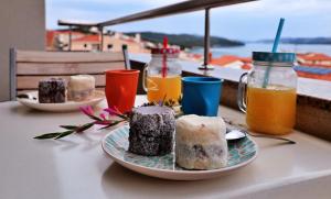 a table with two plates of food and drinks at Apartment Carole in Trogir
