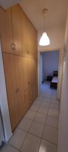 a room with a hallway with cabinets and a couch at KANALI HOLIDAYS APARTMENT in Kanali
