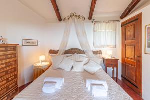 a bedroom with a large white bed with two lamps at [PORTO CERVO- PANTOGIA, INCANTEVOLE VISTA SUL MARE] in Porto Cervo