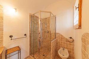 a bathroom with a shower and a toilet at [PORTO CERVO- PANTOGIA, INCANTEVOLE VISTA SUL MARE] in Porto Cervo +20 photos