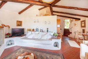 a large bedroom with a large bed and a tv at [PORTO CERVO- PANTOGIA, INCANTEVOLE VISTA SUL MARE] in Porto Cervo