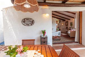 a dining room with a table and a living room at [PORTO CERVO- PANTOGIA, INCANTEVOLE VISTA SUL MARE] in Porto Cervo
