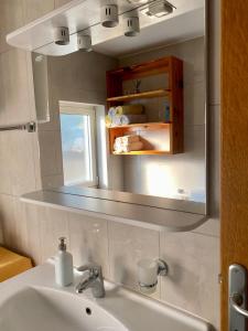 a bathroom with a sink and a mirror at Apartmani Luka in Korčula +31 photos