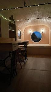 Zimmer mit einem Tisch und einem Fenster mit Beleuchtung in der Unterkunft Glamping MARINGOTKA - malebný ladův kraj in Stříbrná Skalice