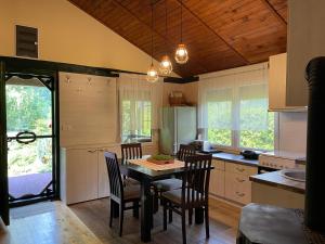 a kitchen with a table and chairs in a room at Drinski kucerak in Okletac