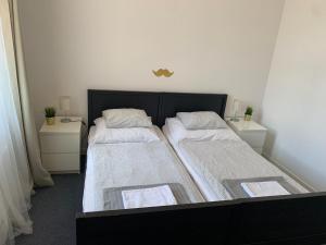 a bedroom with two beds and two night stands at Little Tom Apartments in Prague