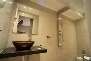 a bathroom with a bowl sink and a shower at Parthenis Riviera Hotel in Athens