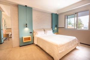 Postel nebo postele na pokoji v ubytování Antares Rooms and Suites